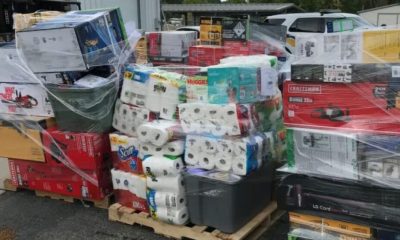 Shrink-wrapped pallets of assorted household goods and tools
