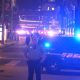 Sheriff deputy standing by patrol cars at night