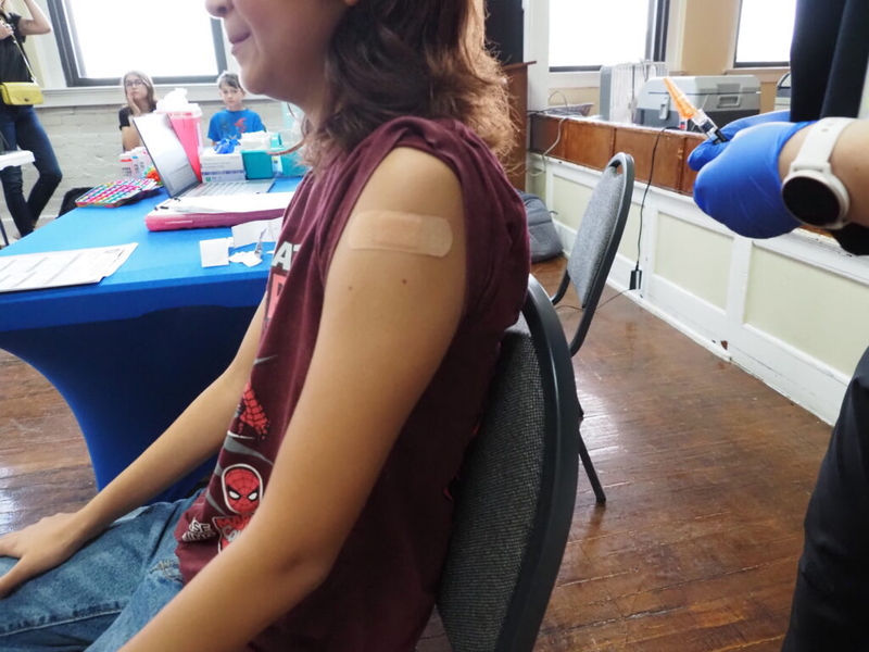 Child receiving vaccination in clinic setting