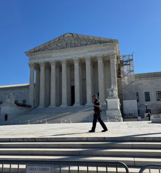 U.S. Supreme Court building with officer walking