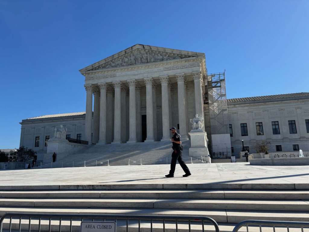 U.S. Supreme Court building with officer walking