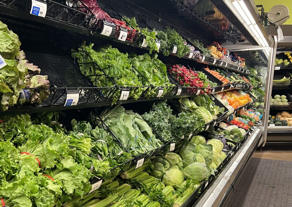 A grocery store produce section filled with various types of fresh greens and vegetables, includ — food recalls Bennington