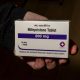 A hand holding a box of mifepristone tablets, labeled 200 mg, emphasizing the medication's i — mifepristone lawsuit paused