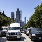 Busy street in New York City with traffic and skyscrapers in the background, incl — new york climate superfund law blocked