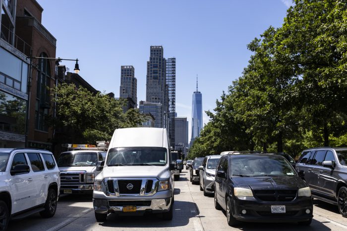 Busy street in New York City with traffic and skyscrapers in the background, incl — new york climate superfund law blocked