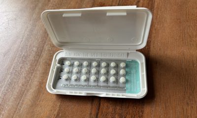 A pack of birth control pills open on a wooden surface, highlighting the days of the week o — birth control misinformation