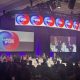Panel discussion featuring multiple governors on stage at a conference, with a large scre — governor phil scott federalism