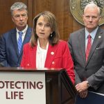 Louisiana Attorney General Liz Murrill speaks at a podium labeled 'Protecting — Massachusetts abortion shield law lawsuit