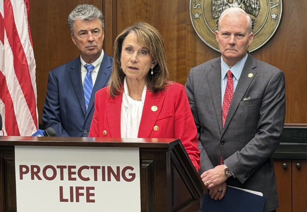 Louisiana Attorney General Liz Murrill speaks at a podium labeled 'Protecting — Massachusetts abortion shield law lawsuit