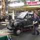 An auto worker in a factory is assembling a vehicle amidst machinery and equipment, highlighting — Trump Canada trade war