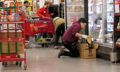 Employee stocking frozen food in grocery store aisle — minimum wage increases july