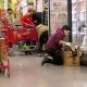 Employee stocking frozen food in grocery store aisle — minimum wage increases july