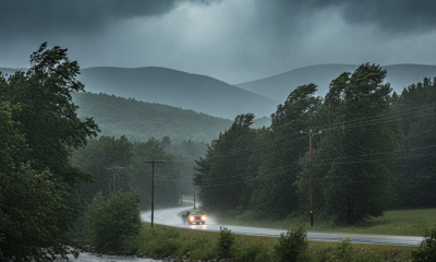 A winding road through a lush landscape under dark storm clouds, with a car driving i — Bennington County weather forecast