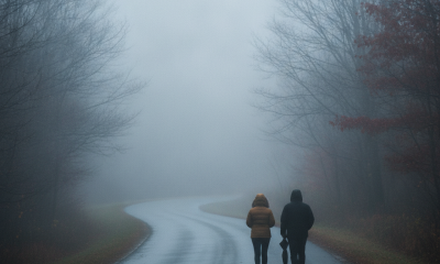Two people walking on a foggy road in Bennington County, surrounded by trees with aut — Bennington County weather forecast
