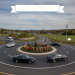 Vehicles navigating the newly completed Bennington Route 67A roundabout, featuring landscaped center and clear road markings.
