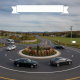 Vehicles navigating the newly completed Bennington Route 67A roundabout, featuring landscaped center and clear road markings.