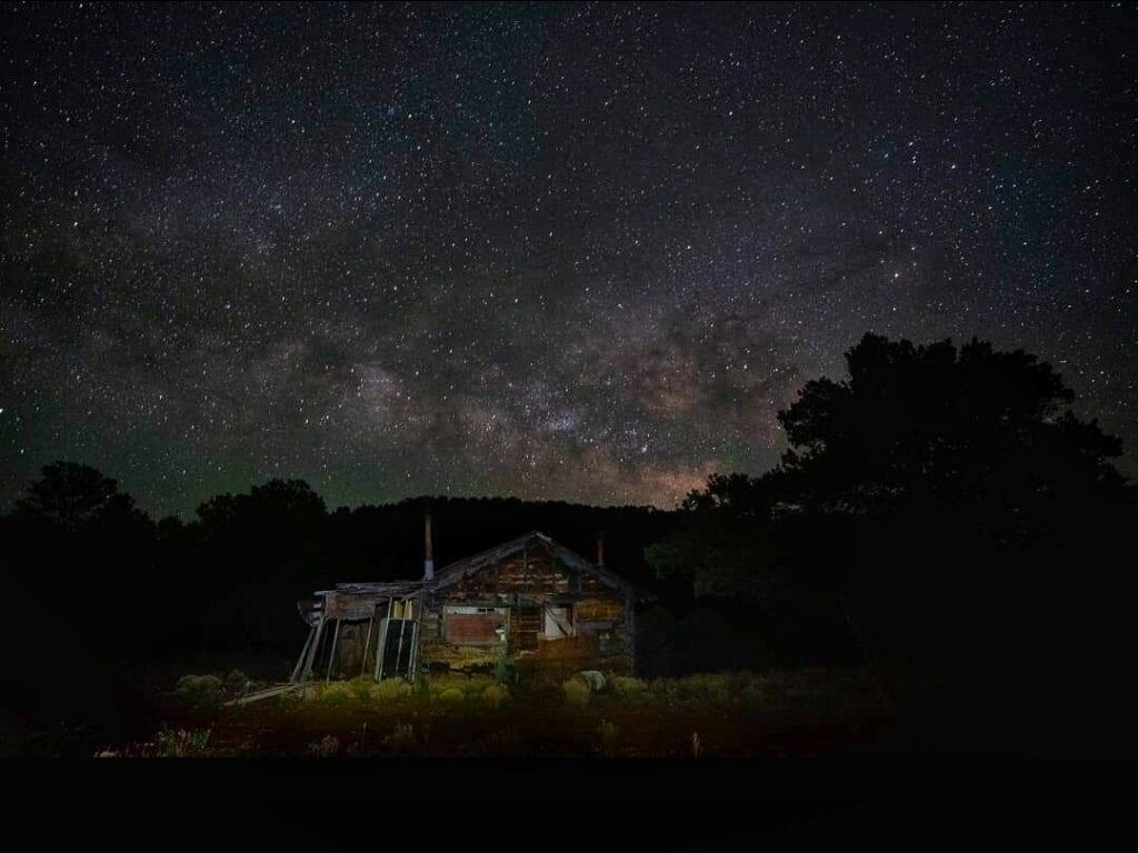 Rustic cabin under Milky Way night sky — Escambia County aging population