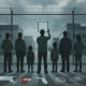 Group of people standing by a fence, looking at an immigrant detention facility — immigrant detention facility inspections