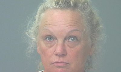 Woman in orange shirt facing camera against gray background — Gulf Breeze animal cruelty arrest