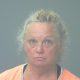 Woman in orange shirt facing camera against gray background — Gulf Breeze animal cruelty arrest