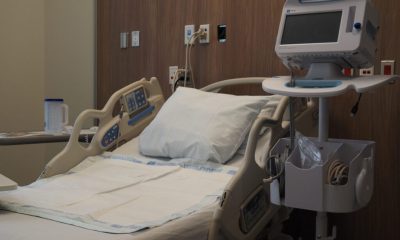 Empty hospital bed in a medical room with monitoring equipment nearby, reflecting hea — Medicaid work requirements lawsuit