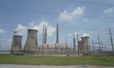 Coal and natural gas power plant with cooling towers and power lines under a cloudy sky, — Trump EPA power plant emissions