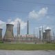 Coal and natural gas power plant with cooling towers and power lines under a cloudy sky, — Trump EPA power plant emissions