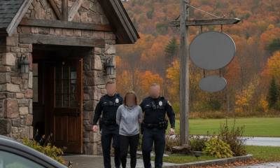 Two police officers escort a woman outside a stone building in Bennington, VT, with autumn — Sadie Mae Olden Bennington VT