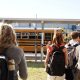 Students walking towards a yellow school bus on a sunny day, highlighting school safety measures. — school panic alarms