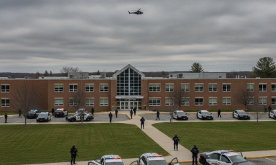 Police vehicles respond outside a building amid Southern Vermont school swatting threats.