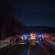 Two vehicles involved in a collision on a snowy road at night, with police and emergency vehicle — Shaftsbury VT car crash