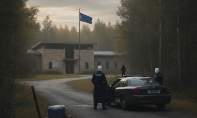 Two police officers near a patrol car at a wooded area with a drone flying overhead, rep — Shaftsbury VT unlawful trespass
