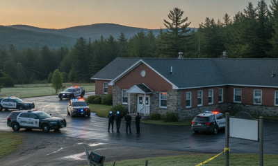 Vermont State Police officers at Shaftsbury Barracks with police vehicles and c — Vermont State Police Shaftsbury Barracks
