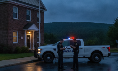 Two police officers discussing near a police vehicle outside the Shaftsbury Barrac — Shaftsbury Barracks DUI investigation