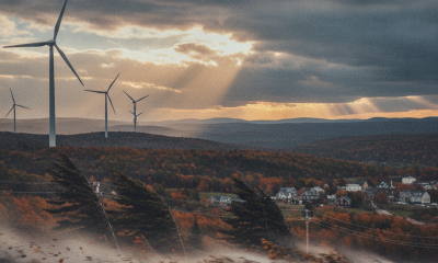 Wind turbines in a landscape with autumn foliage and dramatic clouds, indicating a wind — Wind Advisory Bennington County