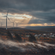 Wind turbines in a landscape with autumn foliage and dramatic clouds, indicating a wind — Wind Advisory Bennington County