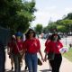 AAPI women walk together along a sunny Washington, D.C., sidewalk, carrying bags and wear — AAPI Women Reproductive Health