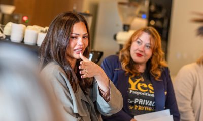 Chrissy Teigen Idaho abortion advocacy: Teigen speaks beside a woman wearing a “Yes” campaign shirt.