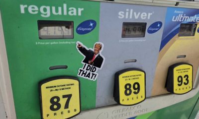 Gas pump showing fuel prices with a sticker of a man pointing and saying 'I DID THAT!' — states suspending gas tax
