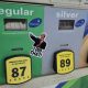 Gas pump showing fuel prices with a sticker of a man pointing and saying 'I DID THAT!' — states suspending gas tax