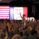 A crowd raises their hands in response to a speaker at a political rally with Am — Democrats majority of governors offices