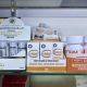Display of kratom products including extracts and capsules on a store shelf, highlighting kratom and 7-OH laws.
