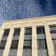 Facade of a county courthouse with a cloudy sky above, symbolizing justice — district attorney elections prison admissions