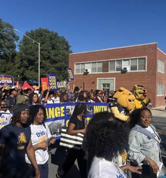 College Student Voting Access rally with students carrying voter signs and university mascots marching along a campus street