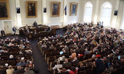 A packed legislative chamber with numerous attendees and officials, highlig — state legislative races competitive chambers