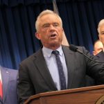 Robert F. Kennedy Jr. speaking at a podium with two men in suits behind him, in a formal — FDA abortion pill safety review
