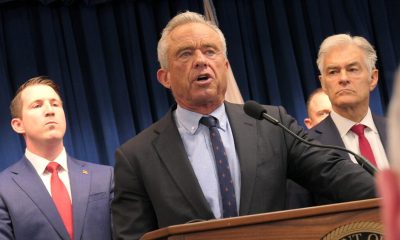 Robert F. Kennedy Jr. speaking at a podium with two men in suits behind him, in a formal — FDA abortion pill safety review