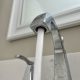 Close-up of a kitchen faucet with water flowing, highlighting rising household water bills.