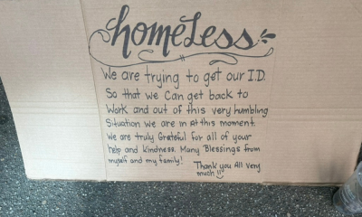 A cardboard sign reading about the struggle to obtain ID and gratitude for help, placed i — NYC Homeless Encampment Sweeps