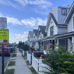 Rockland County Murder Trial Witness story context: quiet residential street with parked cars, homes, and parking signs
